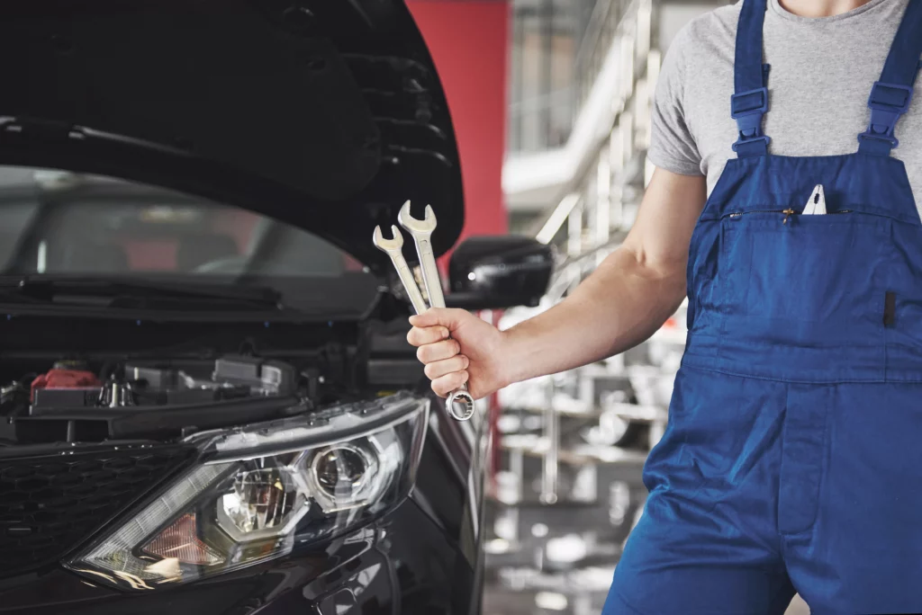 03hand car mechanic with wrench auto repair garage