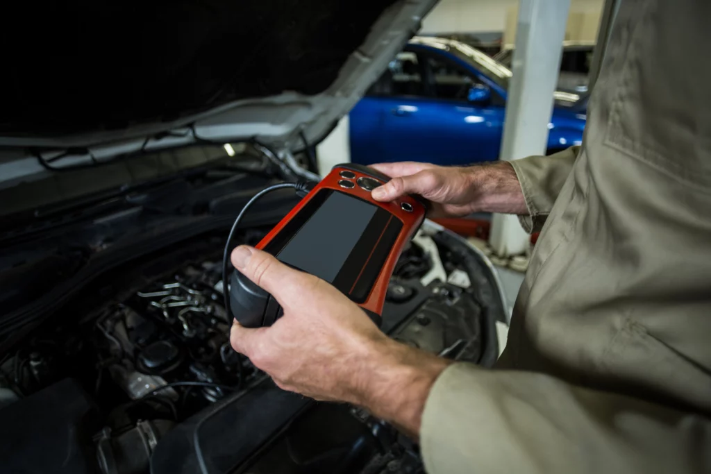 04hands mechanic using diagnostic tool